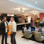 Group event gathering inside the community kitchen and lounge space at Wanderstay Boutique Hotel, a unique hotel Houston offering full-property buyouts.